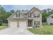 Charming two-story home featuring a brick facade, well-manicured lawn, and a two-car garage for curb appeal at 446 Vandenburg Dr, Villa Rica, GA 30180