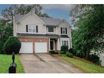 Charming two-story home with a two-car garage and well-maintained lawn at 365 Hunt Creek Dr, Acworth, GA 30101