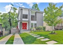 Modern two-story home with a red front door, stone accents and landscaped front yard at 120 Vanira Se Ave, Atlanta, GA 30315