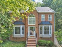 Charming two-story brick home with a large front window, bay windows, and landscaped front yard at 1625 Clark Lake Nw Dr, Acworth, GA 30102