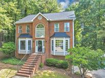 Charming brick home featuring a beautiful brick facade and mature trees surrounding the property at 1625 Clark Lake Nw Dr, Acworth, GA 30102