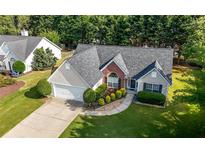 Aerial view of a well-maintained house, landscaped yard, and neighborhood at 3313 Harmon Ridge Ct, Buford, GA 30519