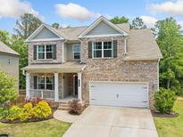 Charming two-story brick home with a well-manicured lawn and covered front porch at 178 Crestbrook Way, Dallas, GA 30157
