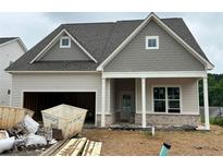 Charming single-Gathering home features a craftsman-style design and an attached two-car garage at 2000 Homestead Ct, Woodstock, GA 30189