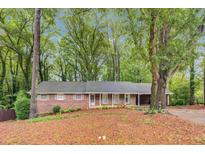 Charming one-story brick home with large, mature trees, lovely greenery and a nice front yard at 333 Lynne Cir, Alpharetta, GA 30009