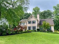 Beautiful two-story home with a lush green lawn and mature trees at 2145 Kensington Sw Ct, Marietta, GA 30064