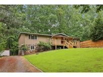 Charming home with a blend of stone and siding, a well-maintained lawn, and a inviting front porch at 3115 Chimney Cove Ln, Cumming, GA 30041