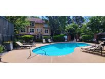 Enjoy the community pool with lounge chairs and tables for relaxing outdoors at 380 Grant Se Cir # 110, Atlanta, GA 30315