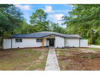 Charming single story home with a painted brick facade, and newly landscaped front yard at 1377 Hill Sw Dr, Conyers, GA 30094