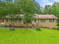 Charming single-story brick home with a well-manicured front yard and mature trees at 2095 Gherry Dr, Austell, GA 30106