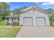 Charming home featuring a two-car garage and welcoming front porch perfect for enjoying the outdoors at 6402 Grafton Ct, Austell, GA 30168