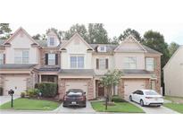 Charming townhome with a well-manicured lawn and inviting curb appeal at 3130 Haynes Park Dr, Lithonia, GA 30038
