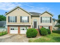 Charming two-story home with a two-car garage and well-manicured lawn at 2175 Golden Valley Dr, Lawrenceville, GA 30043
