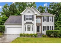 Charming two-story home with stone accents, well-manicured lawn, and a two-car garage at 570 White Stag Ct, Suwanee, GA 30024