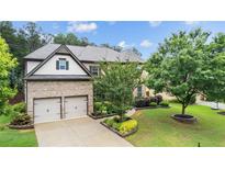 Beautiful two-story brick home with a two car garage and manicured lawn at 2040 Bloomfield Ct, Cumming, GA 30041