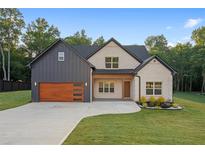 Charming home featuring a mix of brick and board-and-batten siding, and a well-manicured lawn at 859 N Bay Overlook, Villa Rica, GA 30180