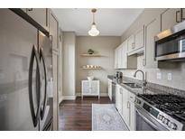 Stylish kitchen with stainless steel appliances, granite countertops, and hardwood floors at 2626 Peachtree Nw Rd # 1108, Atlanta, GA 30305