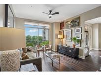 Inviting living room with dark wood floors, balcony access, and a stylish decor at 2626 Peachtree Nw Rd # 1108, Atlanta, GA 30305