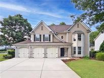 Charming two-story home featuring a three-car garage and well-maintained landscaping at 3260 Caney Creek Ln, Cumming, GA 30041
