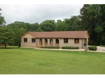 Charming single-story brick home with arched entries and a well-manicured lawn at 5513 N Richland Creek Rd, Buford, GA 30518