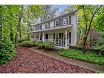 Charming two-story home with inviting front porch and lush, mature landscaping at 6360 Lakeview Ter, Douglasville, GA 30135