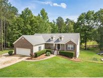 Charming single Gathering home with a beautiful front yard and a brick facade at 1623 Pratt Rd, Covington, GA 30014