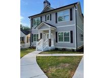 Charming two-story home with gray siding, dark shutters, and a welcoming front porch at 2668 Memorial Se Dr, Atlanta, GA 30317
