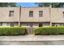 Charming townhome featuring a unique roofline and tidy front yard landscaping at 6433 Stone Terrace Ter, Morrow, GA 30260