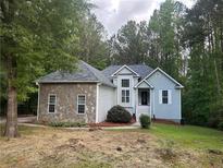 Charming single-Gathering home with stone accents, a well-maintained lawn, and mature trees at 377 Tapley Rd, Villa Rica, GA 30180