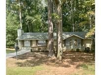 Ranch-style home with a charming front yard surrounded by mature trees at 2058 Pair Sw Rd, Marietta, GA 30008