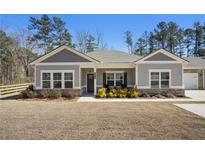Charming single-story home featuring a well-manicured lawn, inviting front porch, and neutral-colored siding for great curb appeal at 3891 Shelleydale Dr, Powder Springs, GA 30127