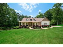 Charming home with landscaped front yard and inviting covered front porch at 7131 Ridge Rd, Hiram, GA 30141