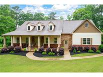 Charming home with a stone and siding facade, covered porch, and well-manicured landscaping at 7131 Ridge Rd, Hiram, GA 30141