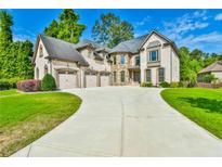 Elegant brick home with a three-car garage and a large, beautifully landscaped front yard at 5121 Hope Sw Ct, Lilburn, GA 30047