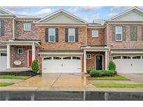 Charming townhome with a one car garage and manicured front lawn at 218 Ellis Ln, Woodstock, GA 30189