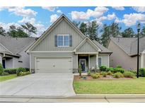 Charming, single-story home boasts a manicured lawn, attached garage and welcoming front porch at 3112 Patriot Sw Sq, Marietta, GA 30064