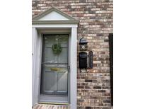 Charming front door with classic brick, traditional address plaque and wreath at 2435 Northlake Ct, Atlanta, GA 30345