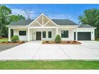 Beautiful new construction home featuring a modern farmhouse design, a spacious driveway, and a welcoming front porch at 4824 Se Highway 20, Conyers, GA 30013