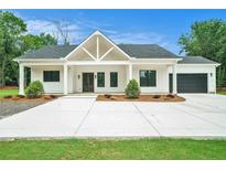 Charming single-story home featuring a modern farmhouse style with a welcoming front porch at 4824 Se Highway 20, Conyers, GA 30013