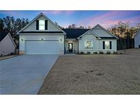 Charming single-story home with a two-car garage, landscaped front yard, and neutral-colored siding at 180 Eryn Ter, Covington, GA 30014