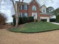 Charming two-story brick home featuring a well-maintained front lawn and inviting curb appeal at 230 Channings Lake Dr, Lawrenceville, GA 30043