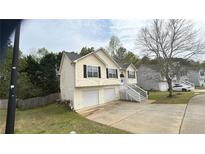 Charming two-story home with a two-car garage and welcoming front porch in a suburban neighborhood at 362 Summer Hill St, Stockbridge, GA 30281