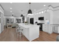 Bright, spacious kitchen featuring a center island, stainless steel appliances, and an open layout to the living room at 208 Wade Creek Rd, Alpharetta, GA 30009