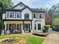 Beautiful two-story home with a covered porch, shutters, and brick accents at 710 Oxford Crest Ct, Lawrenceville, GA 30043