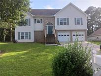 Charming two-story home featuring a well-manicured lawn and a two-car garage at 2775 Emerald Springs Dr, Lawrenceville, GA 30045