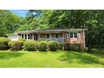 Charming single-story brick home with well-maintained lawn and mature landscaping at 766 Virginia Cir, Forest Park, GA 30297