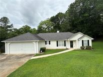 Charming single-story home featuring a well-manicured lawn and an attached two-car garage at 6328 Wellington Ct, Douglasville, GA 30134