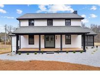 Charming two-story home with a welcoming front porch and a fresh, modern exterior at 260 Sandy Lake Cir, Fayetteville, GA 30214