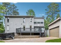 Two-story home with a grey back deck and a detached single car garage at 4117 Signal Sw Rdg, Lilburn, GA 30047