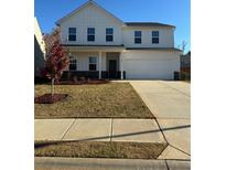 Charming two-story home with a well-manicured lawn and a two-car garage at 136 Paulownia Cir, Mcdonough, GA 30253